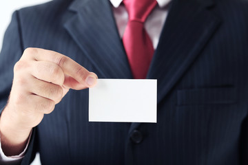 Businessman holding blank card in his hand