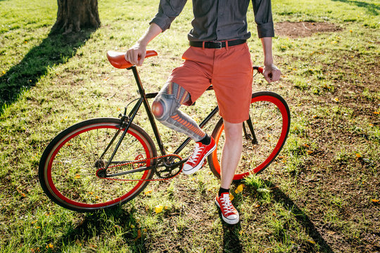 Hipster with bycicle and tattoo on leg