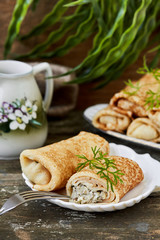 Stuffed pancakes crepes with mushroom and egg.vertical