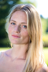 Close up on blond woman with freckles.