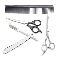 Comb with scissors and razor on a white background