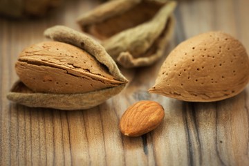 Almonds on brown wooden background