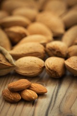 Almonds on brown wooden background