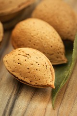 Almonds on brown wooden background