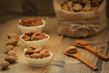 Almonds on brown wooden background