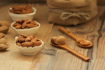 Almonds on brown wooden background