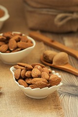 Almonds on brown wooden background