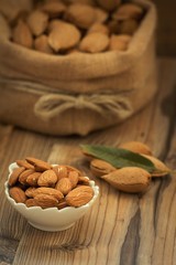 Almonds on brown wooden background