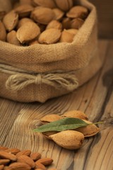 Almonds on brown wooden background