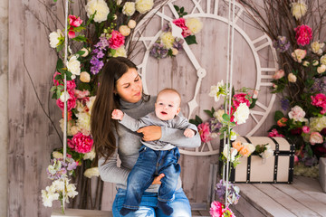 Happy mother with baby boy in the room