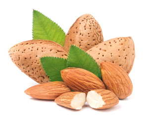 almonds in their skins and peeled with leaf isolated on white background