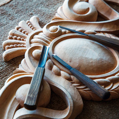 Wood processing. Joinery work. wood carving. a wood carvings, tools on the wooden background close...