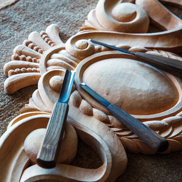 Wood processing. Joinery work. wood carving. a wood carvings, tools on the wooden background close up. use as background