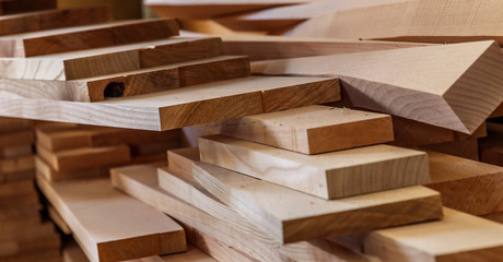 Wood timber construction material for background and texture. close up. Stack of wooden bars. small depth of field