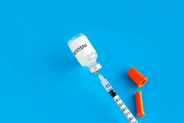 Diabetes concept. Insulin and Syringe on a blue background. World Diabetes Day.