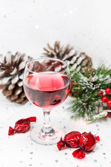 Luxury wine and chocolates with pinecones on a white background.