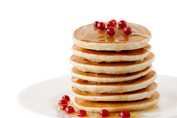 Pancakes with maple syrup and cranberries isolated on a white background. Breakfast, snacks.