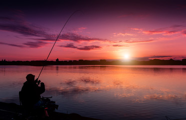 fantastic landscape, multicolor sky over the lake. majestic sunrise. Fishing feeder at sunset. Fisherman silhouette at sunset. use as background. series. creative images.