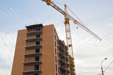 High building crane at the construction site