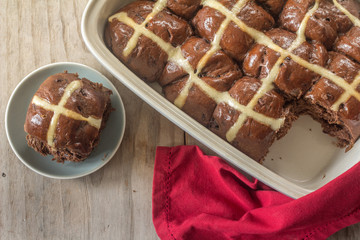 Homemade Chocolate Hot Cross Buns on a Wooden Table from Above