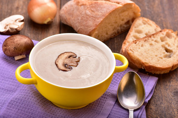 Mushroom cream soup on the wooden table.