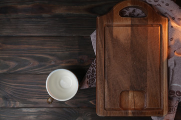 cup with brown wooden cutting board