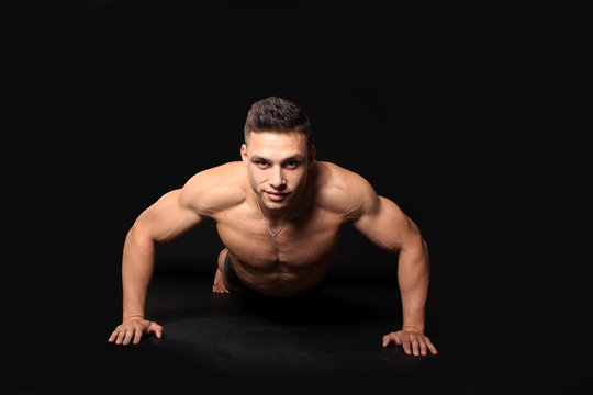 handsome bodybuilder man pushed from the floor showing muscles