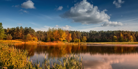 beautiful landscape. wonderful autumn sunny day. sky with majestic clouds over the lake in the forest breathtaking scenery. fantastic picturesque scene. color in nature.