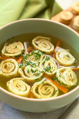 Traditional German Flaedlesuppe and Austrian Frittatensuppe consomme with pancake or crepe and chives, photographed with natural light (Selective Focus, Focus one third into the image)