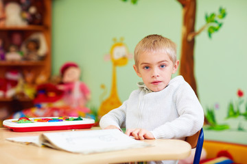 cute boy, kid with special needs learning in rehabilitation center © Olesia Bilkei