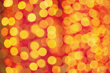 Christmas shiny bokeh in yellow golden colors, new year illunination. Seasonal vintage hipster holiday background.