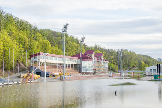 Floded stadium. Words "start", "biathlon" and "finish" in russian on billboards on back