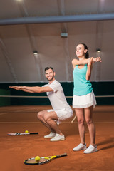Fototapeta na wymiar Positive tennis players doing sport exercises