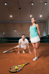 Pleasant sporty tennis players doing sport exercises.