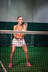 Cheerful smiling woman playing tennis