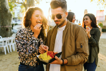 Group of friends visiting eat market in the street.