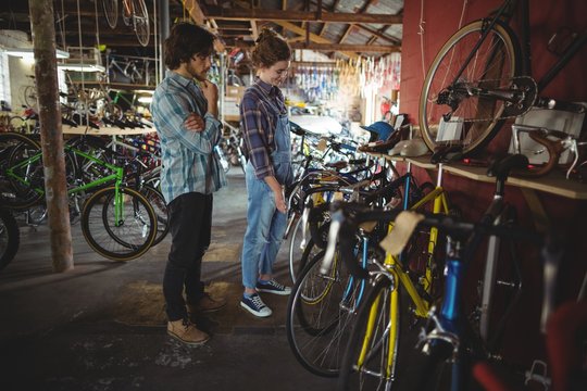 Mechanics examining a bicycle