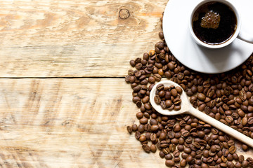 coffee beans on wooden with coffe cup table top view