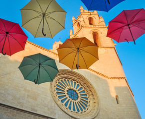 Colored umbrellas against gothic cathedral.
