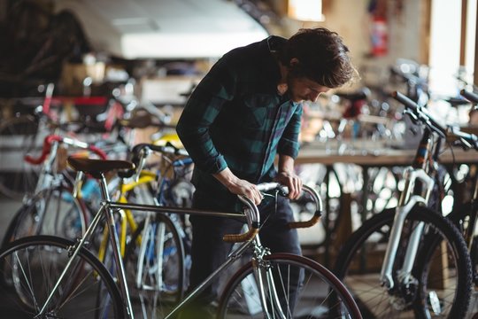 Mechanic examining a bicycle handle bar