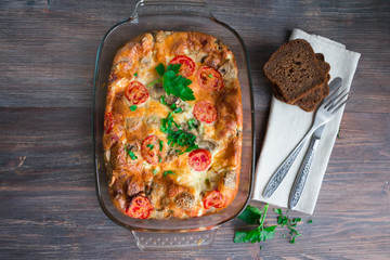 Omelet with champignons, tomatoes, cheese cooked in the oven, gratinated omelette, just cooked on...