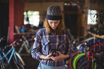 Woman adjusting vintage camera