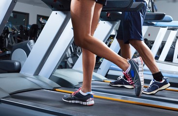 Fototapeta na wymiar Legs on treadmill