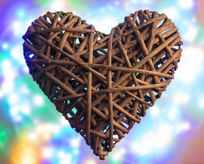 (osier, sallow, vine) braided on a frame in the form of hearts on a background of defocused multicolored LED light - pictures concept theme Love and St. Valentine's Day