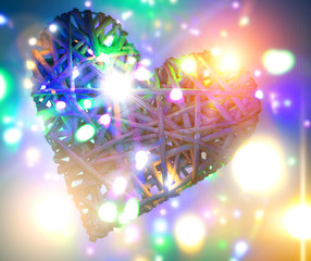 (osier, sallow, vine) braided on a frame in the form of hearts on a background of defocused...