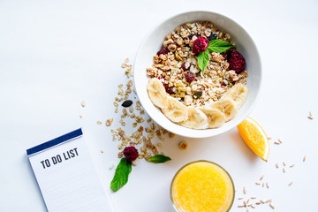 Breakfast with oatmeal and to do list on white background