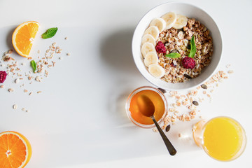 Breakfast with oatmeal and orange juice on white background