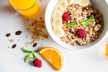 Breakfast with oatmeal and orange juice on white background