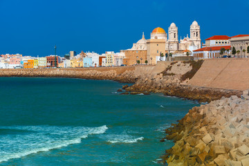 Playa de la Santamaria beach and Cathedral de Santa Cruz in the morning in Cadiz, Andalusia, Spain © Kavalenkava