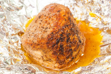 Roasted and baked in foil meat. Pork or beef with spice in sauce